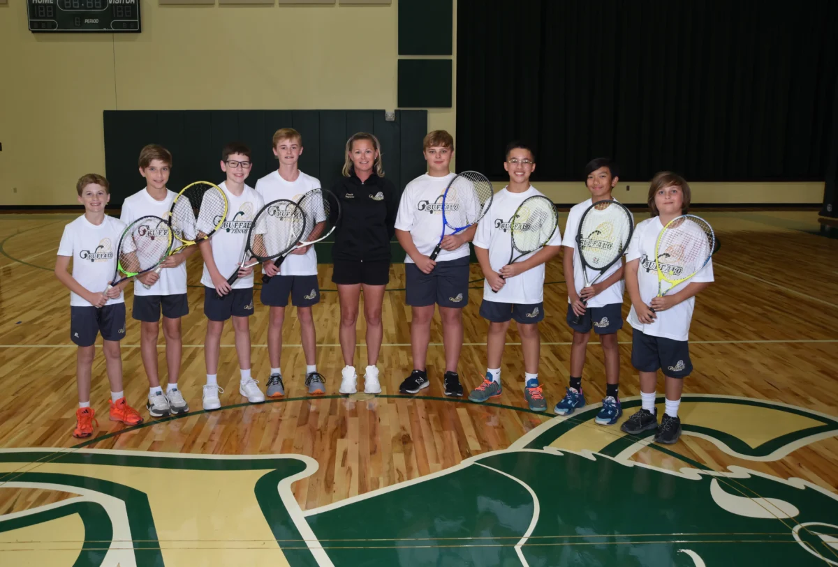 Middle school boys tennis team with coach.